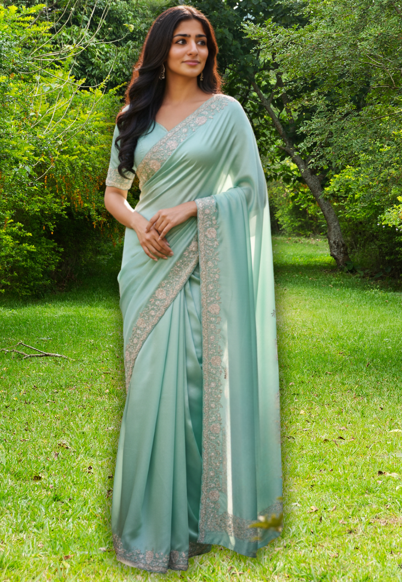 Sea green shamu silk saree with beaded stone work and sequins silver border.