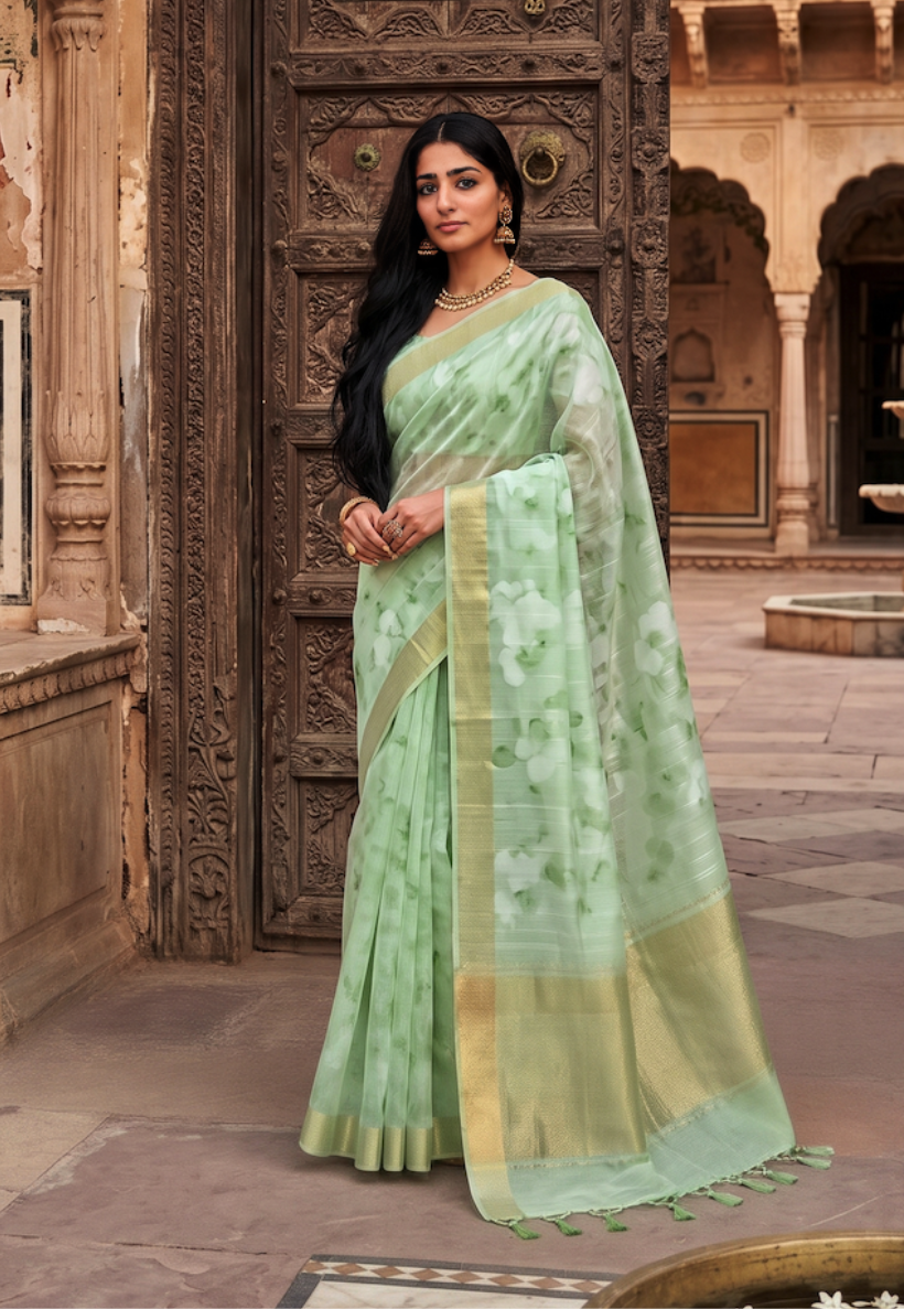 Mint green floral cotton saree with delicate botanical patterns and zari border