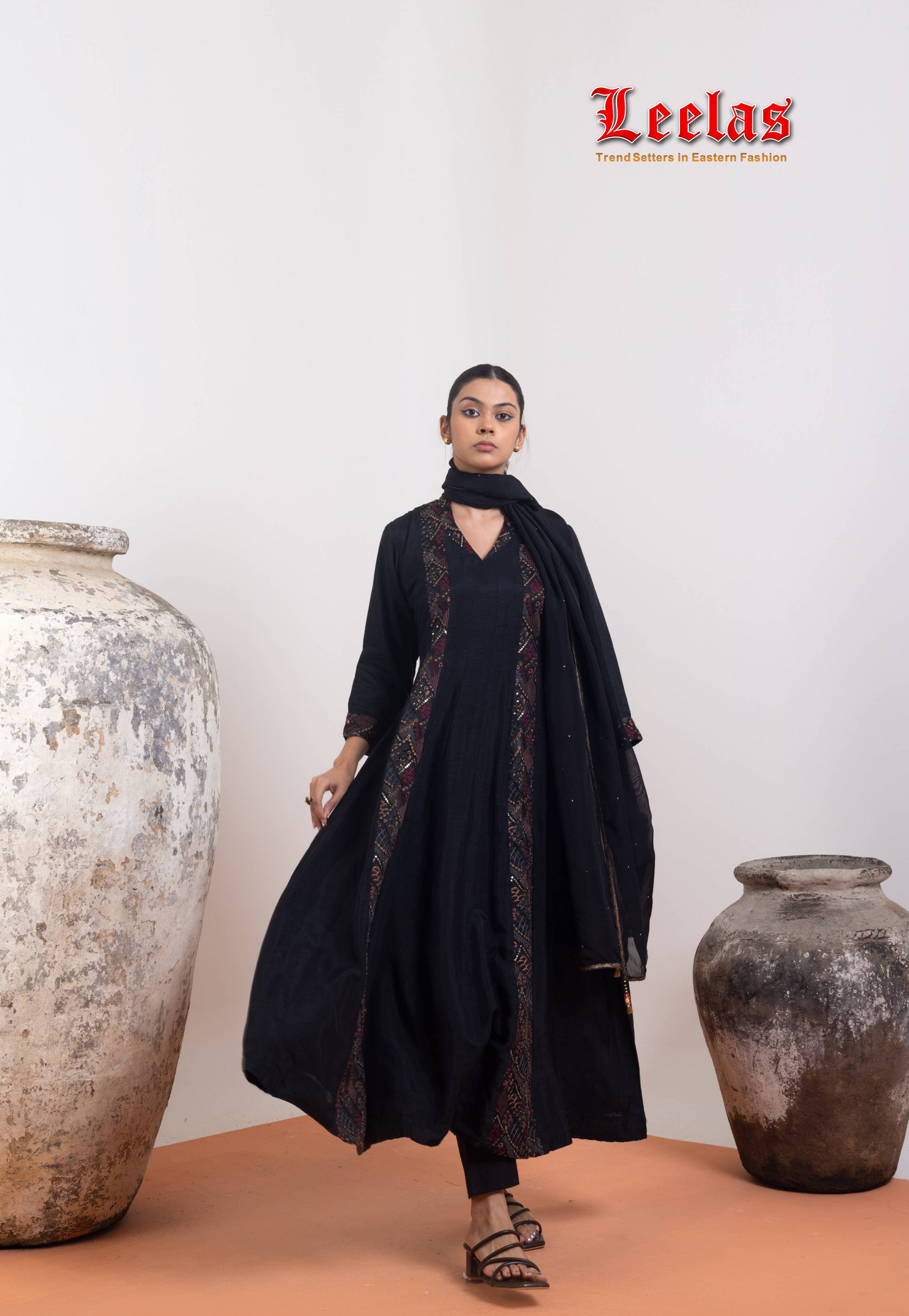 Black and gold silk salwar kameez with embroidery detail on side and neckline
