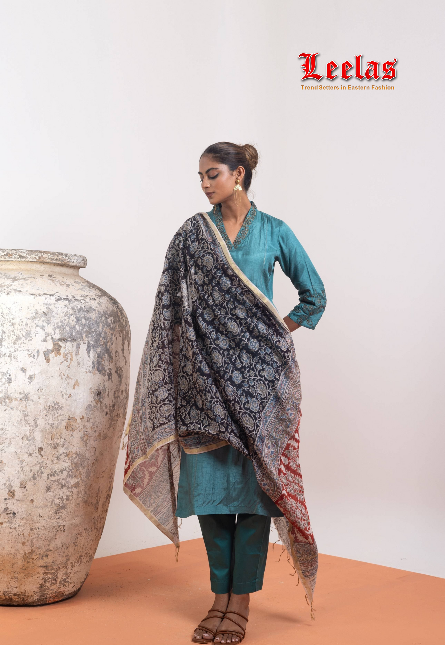 Jade silk salwar kameez with black and gold embroidery on neckline