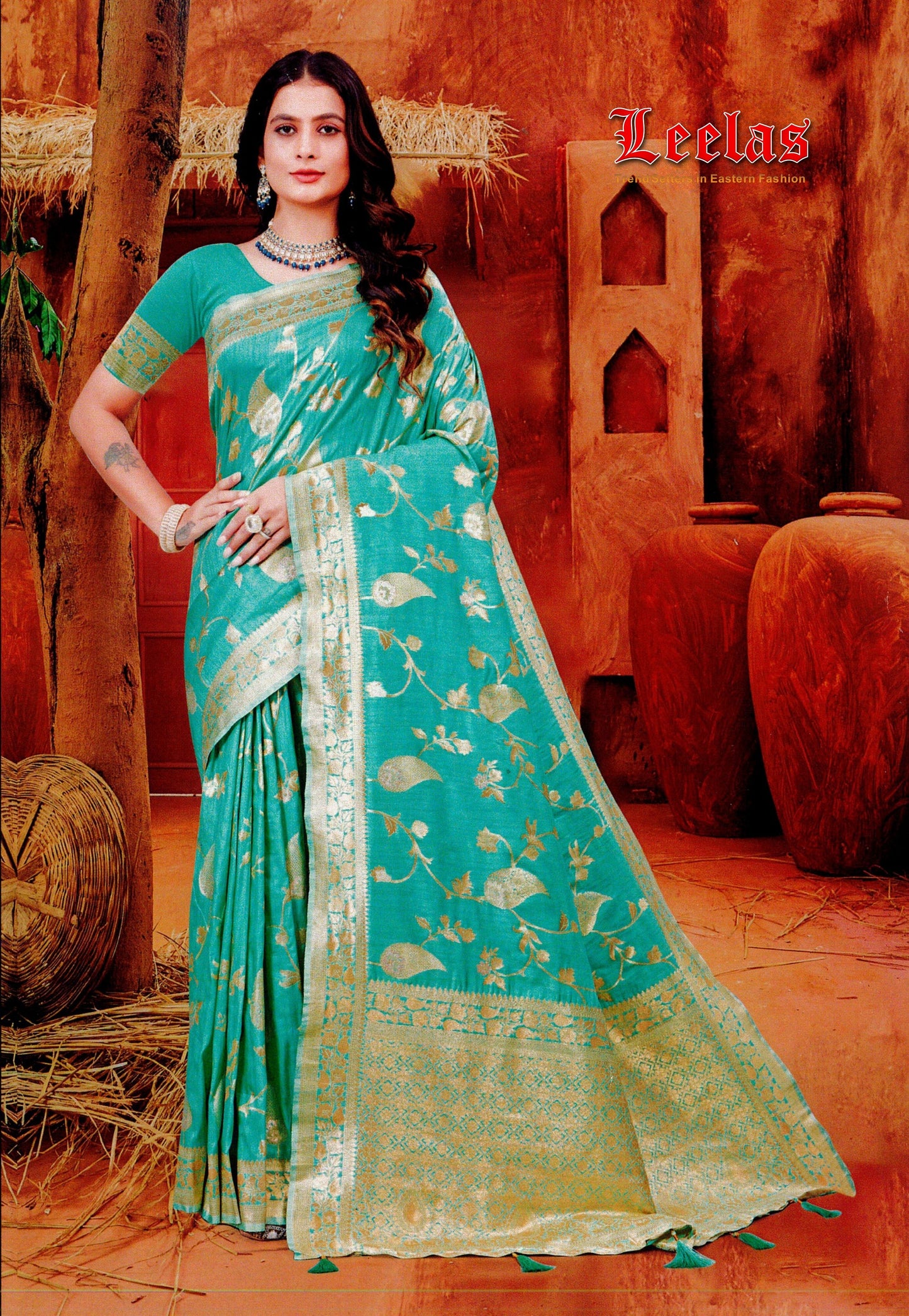 Light turquoise silk saree with gold embossed work