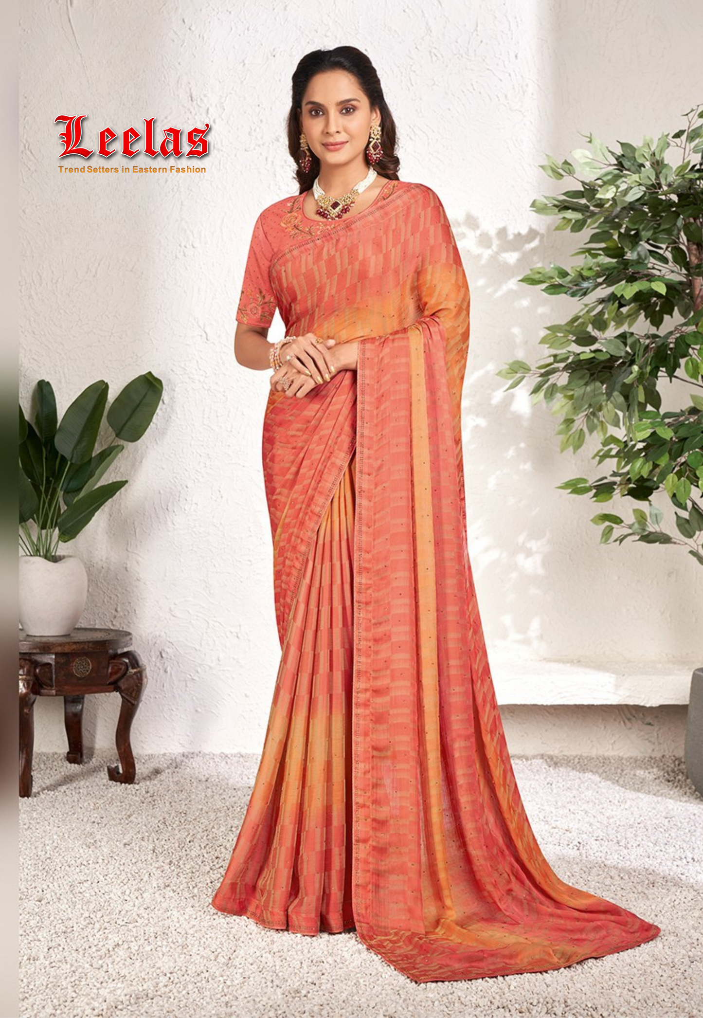 Coral and orange contrasting georgette saree with stonework