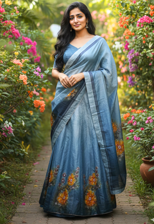 Dual toned blue and grey soft organza lengha adorned with vibrant hand painted orange and yellow floral bead and stonework motifs