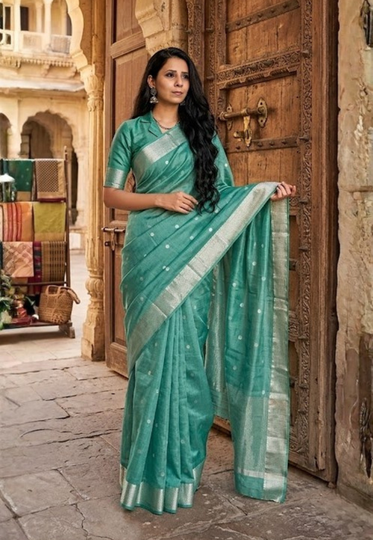 Sage green crepe silk saree with intricate gold toned zari border
