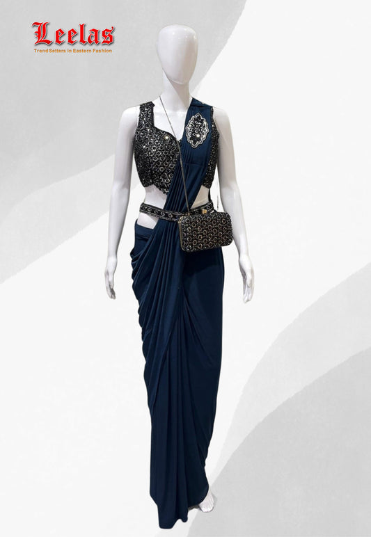 Deep teal silk ready stitched saree with full black beaded and sequin sleeveless ready made blouse, with unstitched sleeves with matching saree belt and hand bag