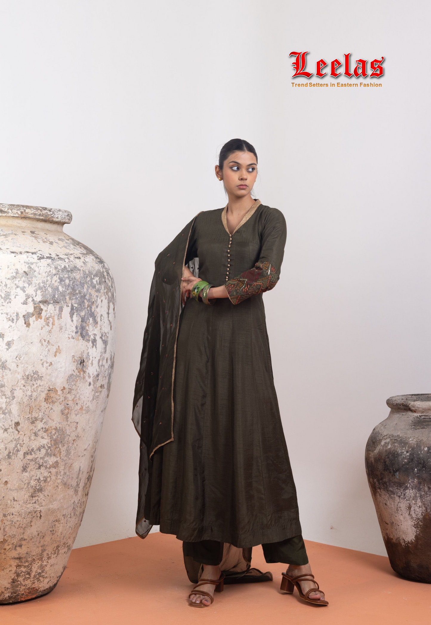 Dark olive green  and gold silk salwar kameez with gold trim on neckline and gold button detail