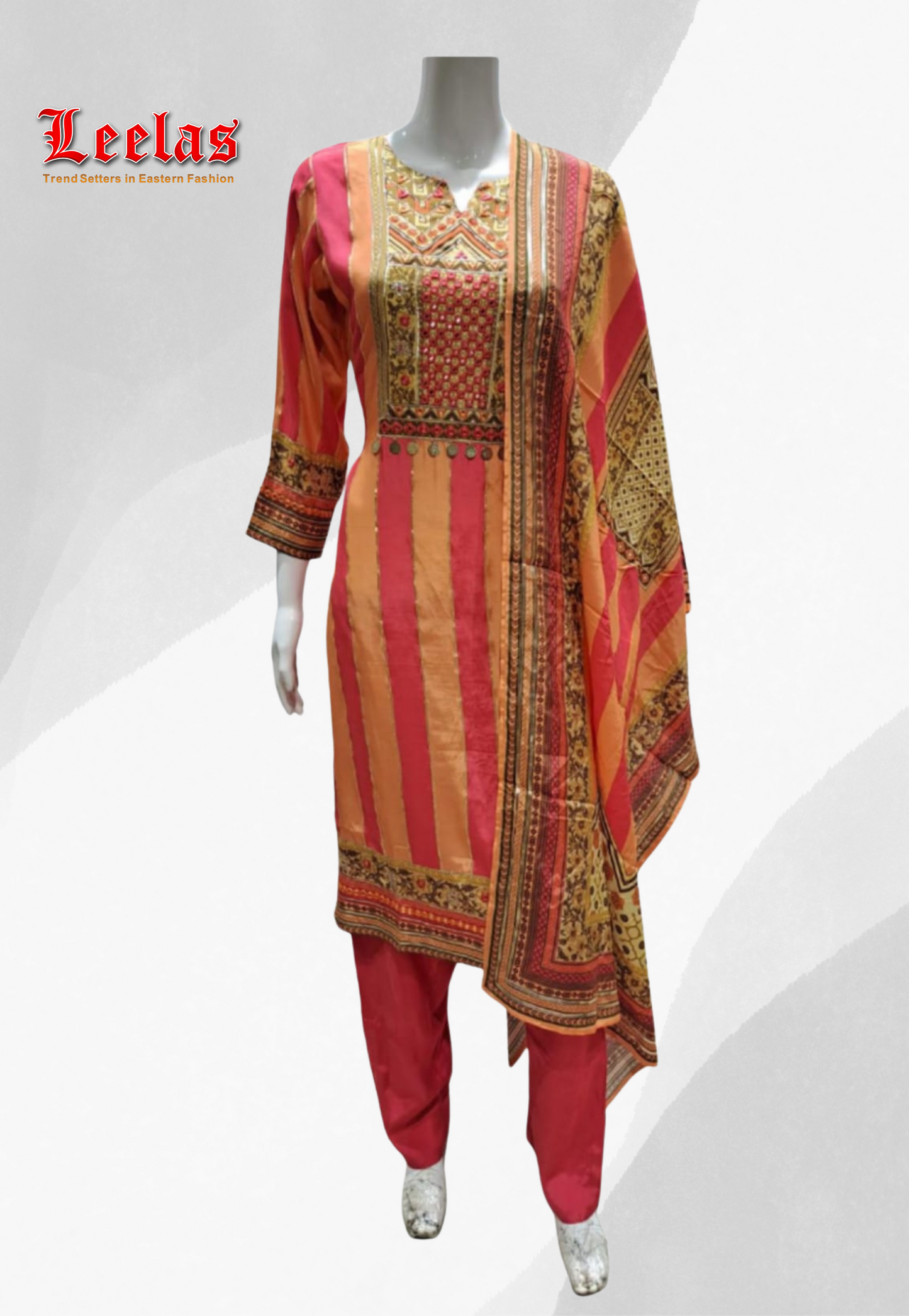 Peach and coral silk printed salwar kameez with embroidery and mirror work on bodice