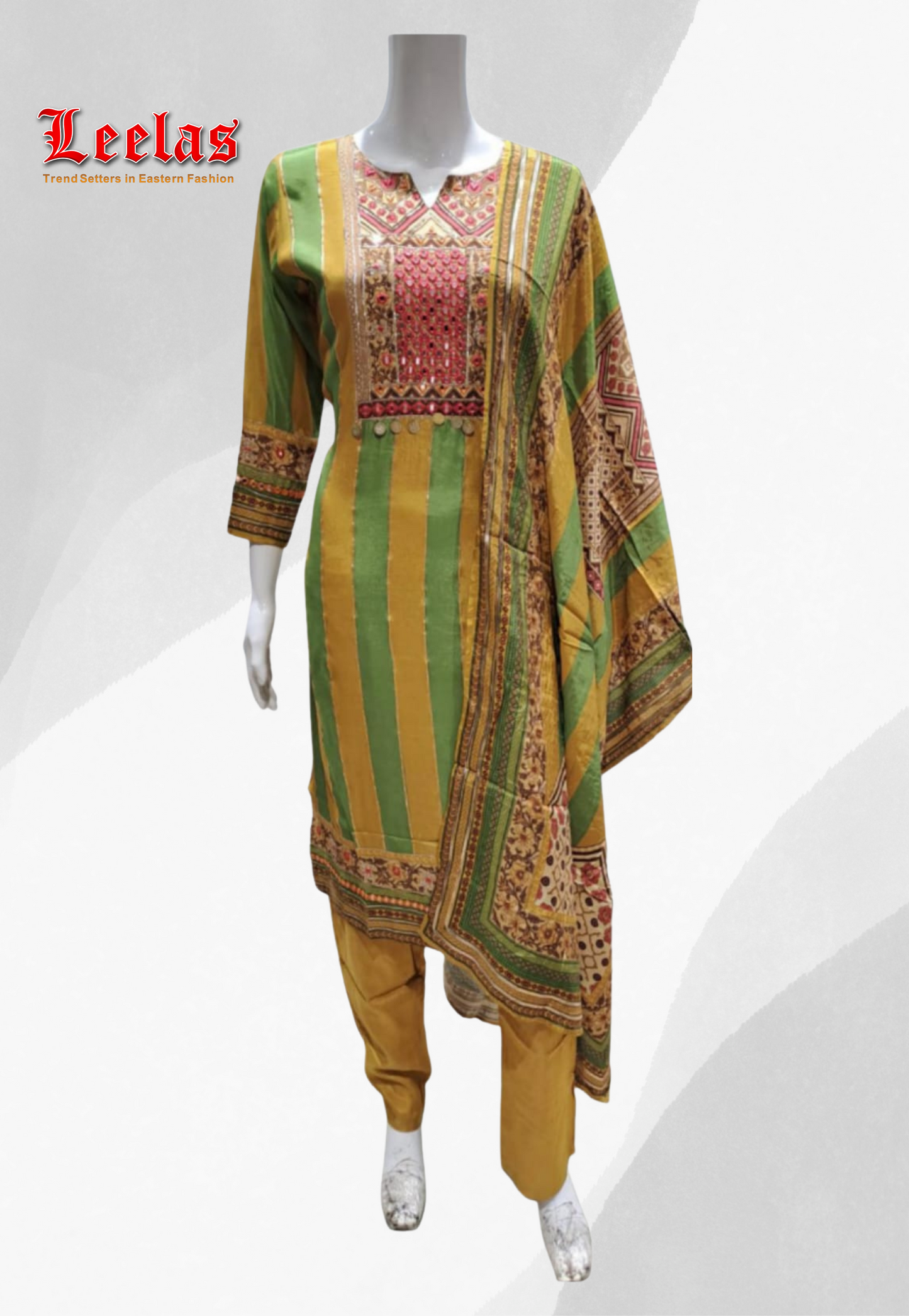 Green and mustard silk printed salwar kameez with embroidery and mirror work on bodice