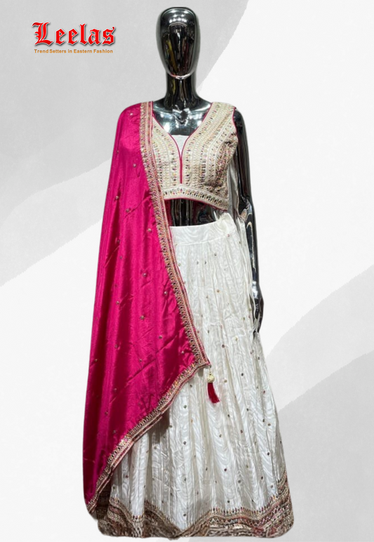 Cream and gold silk lehengha with emboridery and sequin work and cerise pink dupatta