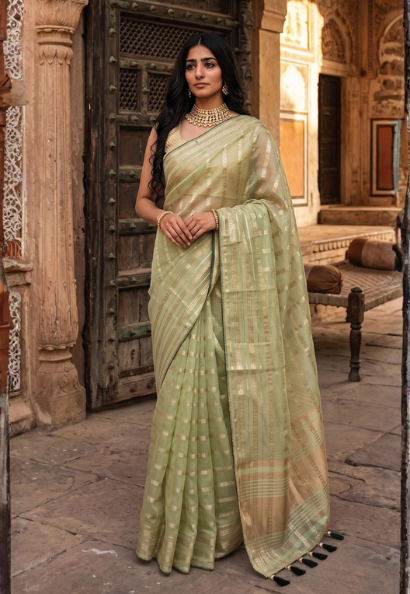 Mint green cotton silk saree with sequins and zari border with bottle green contrasting blouse piece